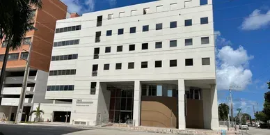 Modern building with large windows and pillars.