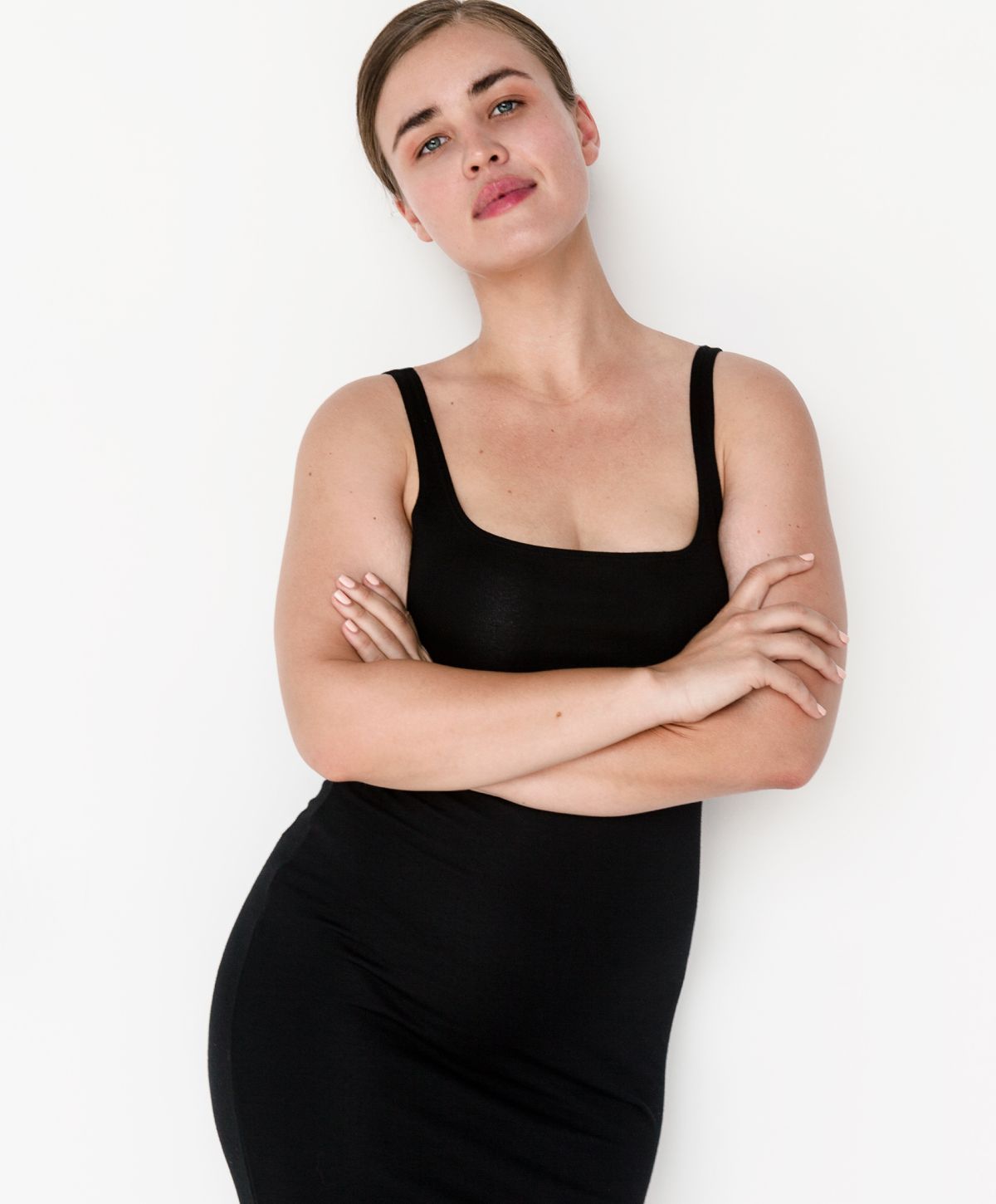 Woman posing confidently in a black dress.