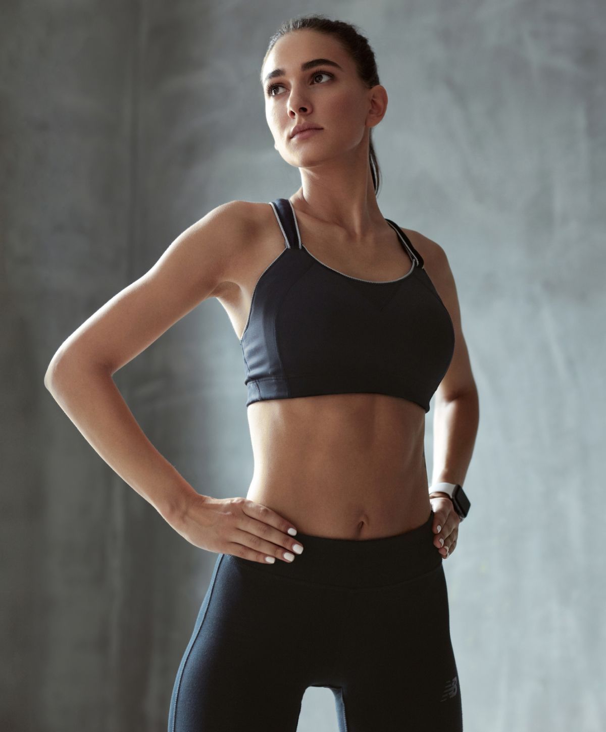 Woman in athletic wear posing confidently.