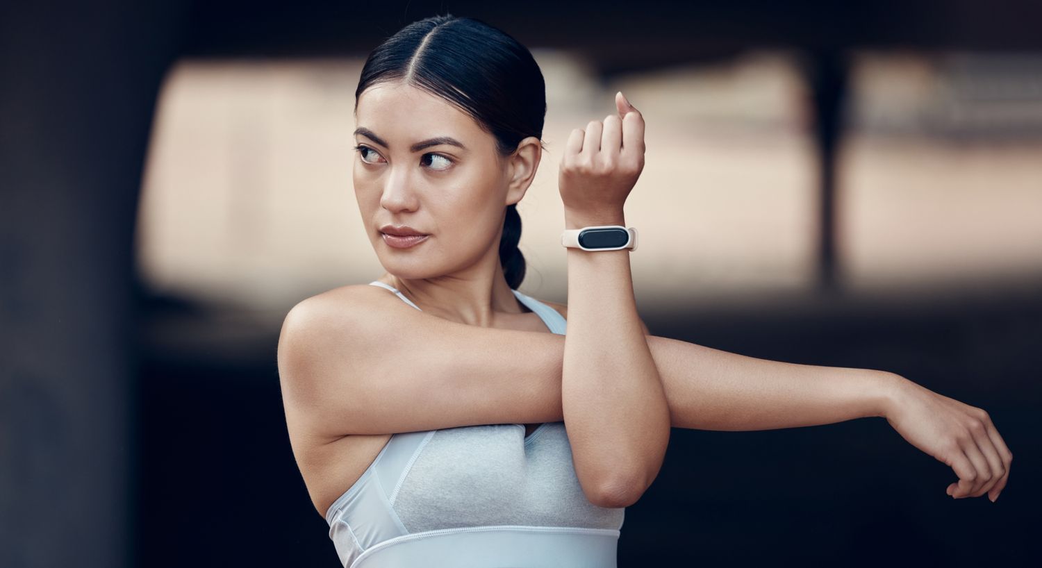 Woman exercising with fitness tracker on wrist.