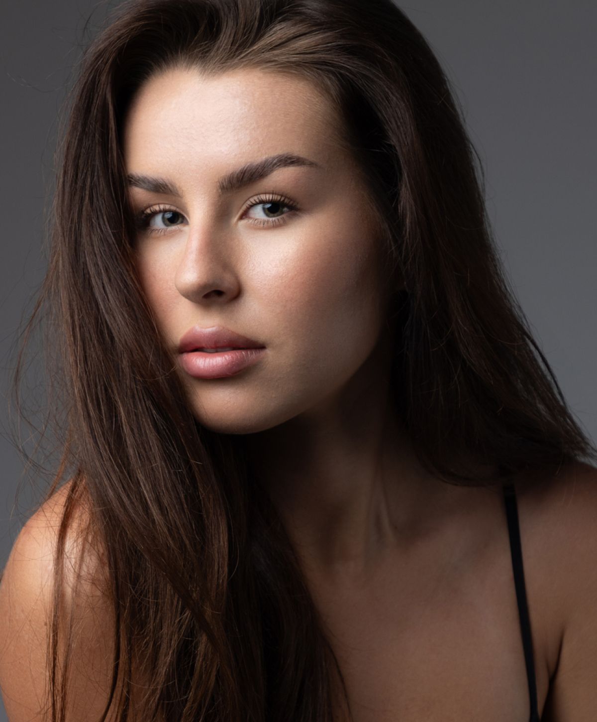 Close-up of a woman with long brown hair.